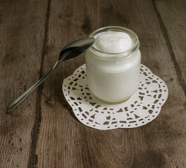 Natural homemade yoghurt in a glass jar. Healthy breakfast with Greek yogurt