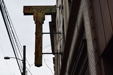 Rusted out old sign attached to abandoned building