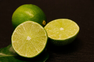 fresh cutted green limes on a black background