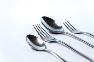 Two forks and two spoons, isolated on white