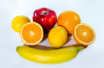 Citrus fruits (orange, lemon), red apple and banana, isolated on white