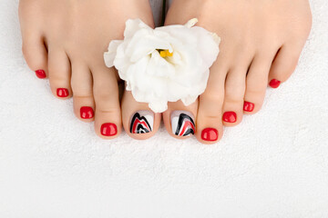 Manicure, pedicure beauty salon concept. Womans feet on gray background