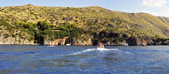 Panoramic wide-screen view of the numerous natural grottos that attract many tourists, boaters and...