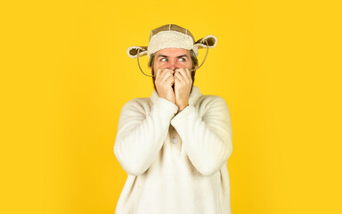 Bearded man wear hat with ear flaps. Furry accessory. Fur garments. Bearded hipster. Winter fashion concept. Warm hat for cold weather. Natural sheep fur. Waiting for warming. Spring is coming