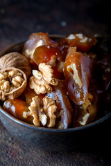 Churchkhela Pestil or Walnut Fruit Pulp in bowl on dark background.