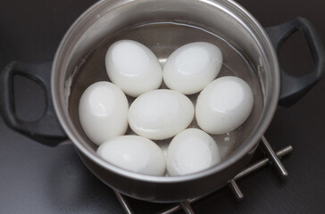 Boiled white eggs in a saucepan, food for breakfast