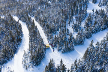 Aerial drone photo of a group of skiers and snowboarders in a snow cat in the Chic Choc Mountains...