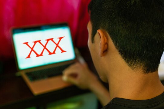 Man watching porn on his computer. Pornography addiction.