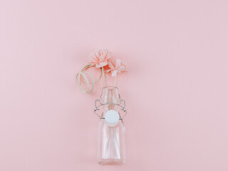 pink flowers in a vase.

A pink flower in a vase lies in the middle on a pink background with a...
