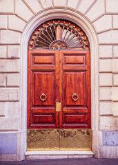 vintage building entrance arched natural wood door, Rome Italy