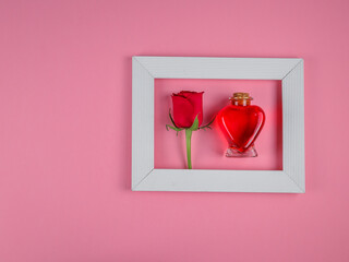 rose and heart.
Rose and heart in a white frame on the right on a pink background with a place for...