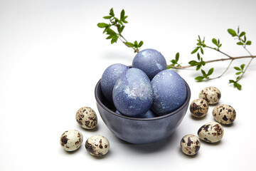 Painted chicken and quail eggs in a bowl