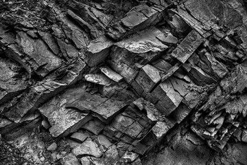 Texture, background layers and cracks in sedimentary rock on cliff face. Cliff of rock mountain. Rock slate in the mountain. Seamless abstract background. Cracks and layers of sandstone.
 - obrazy, fototapety, plakaty