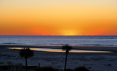 Orange Sun Bursting Through Clouds at Dawn
