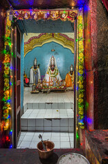 Hampi, Karnataka, India - November 5, 2013: Malyavanta Raghunatha Temple. colorful entrance to inner sanctum with the deity statues: Lakshmana, Rama, Lakshmi. 