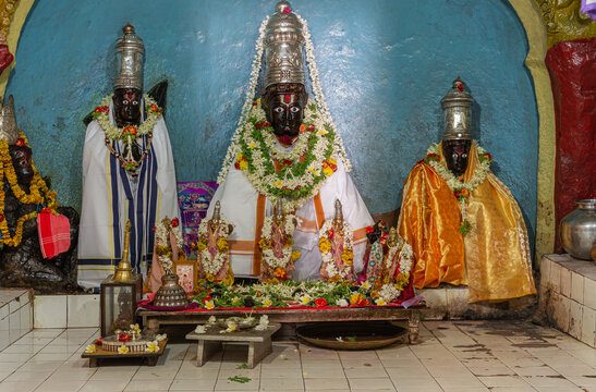 Hampi, Karnataka, India - November 5, 2013: Malyavanta Raghunatha Temple. Closeup of idols in inner sanctum with the deity statues: Lakshmana, Rama, Lakshmi. 