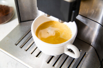 Making a coffee in a coffee machine.