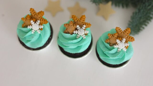 
cupcakes with tiffany cream and snowflakes on a white table