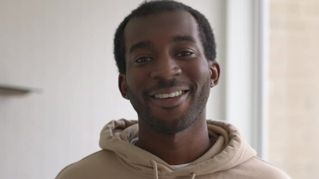 Close up portrait of smiling young man standing in new home - shot in slow motion
