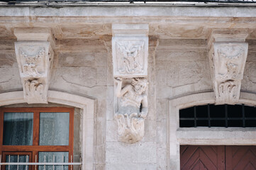 Caryatid in the form of a satyr, holding the balcony of an old house in Lviv. European...