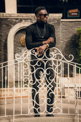 portrait of african model smoking cigar and posing for photography