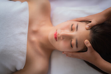 Fototapeta na wymiar woman getting spa facial spa massage treatment at beauty spa salon