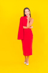 Portrait beautiful young asian woman smile with action on yellow background