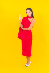 Portrait beautiful young asian woman smile with action on yellow background