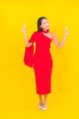 Portrait beautiful young asian woman smile with action on yellow background