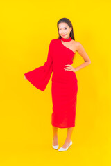 Portrait beautiful young asian woman smile with action on yellow background