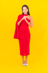 Portrait beautiful young asian woman smile with action on yellow background