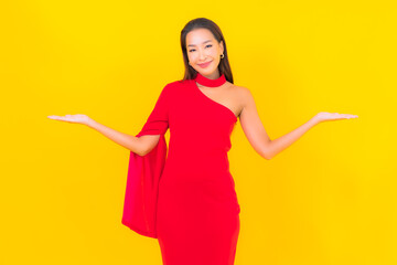 Portrait beautiful young asian woman smile with action on yellow background