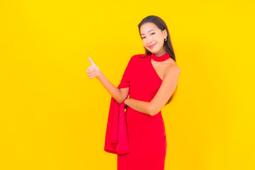 Portrait beautiful young asian woman smile with action on yellow background