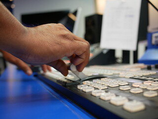 hand on dissolve of switcher buttons in studio TV station,Television Broadcast.