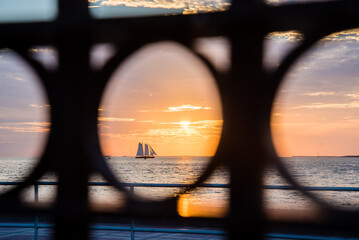 Sailboat sailing into the sunset in key west