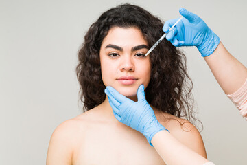 Portrait of a woman getting a rejuvenating facial injection
