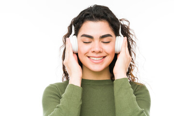 Calm woman listening to a song with headphones