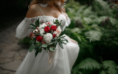The bouquet is in the hands of the bride.