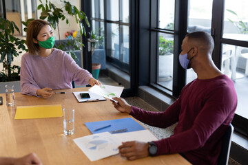 Two diverse business people working in creative office