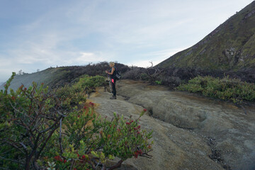 A woman standing at the top of mount Ijen Banyuwangi Indonesia