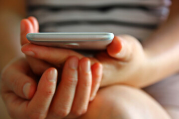 blur picture woman holding mobile in hand