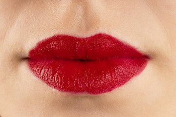 Fototapeta premium Close-up lips of young beautiful woman. Sexy red lips. Lip Makeup. Glossy red lipstick. Panoramic shot. Close-up macro shot. High quality image. Panorama banner.