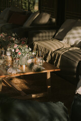 wooden table with personalized glasses, candles and flowers. Decoration for social events.