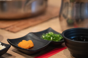 Orange grated radish with chopped spring for mix with ponzu. Japanese sauce