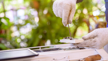 Asian man online learning and repair air conditioner at home. Social distancing and New normal...
