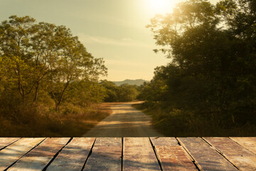 Wooden table on sunset background in nature