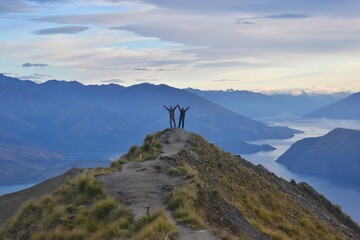 New Zealand, welcoming a new day from Roys Peak. The view to Lake Wanaka and mountains around is just breathtaking! This track is popular one day hike and definitely worth it. - obrazy, fototapety, plakaty