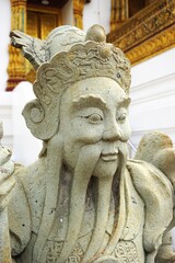 Ancient carved stone statue of an Asian guardian deity