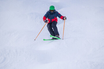 People are enjoying mogul skiing and snow boarding	