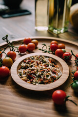 Dried vegetable spices on a wooden tray with cherry tomatoes